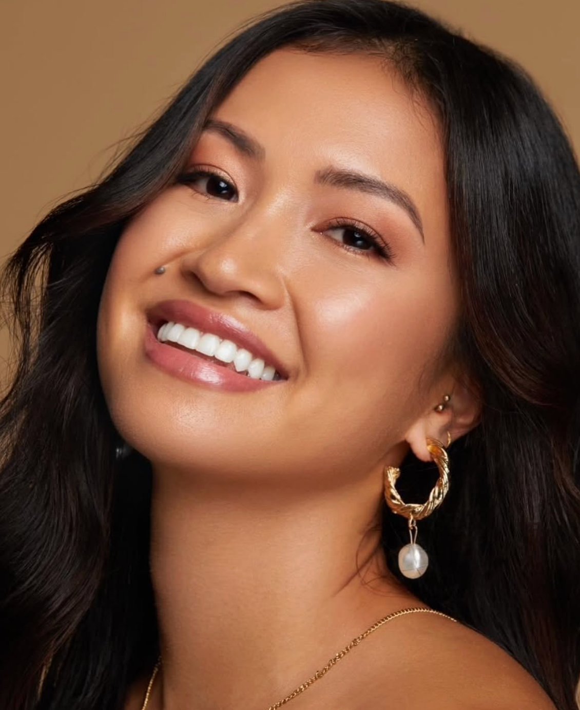 Smiling client with glowing makeup